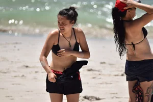 Beach girl can't keep her tits in her bikini