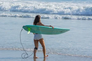 Candid girls surfing on the beach