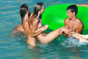 FKK Nudists playing in the water with floater