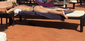 Blonde laying out in a blue bikini with a sexy body