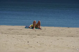 Sexy ass blonde milf on the beach in a thong with cameltoe and bending over