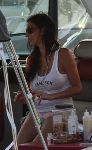 Bikini babe on a boat with a wet see through white shirt showing her tits