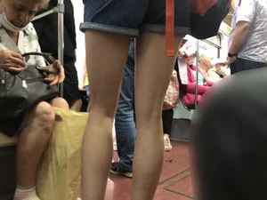 Girl in Shorts Standing in a Subway Train With Spread Legs - Creepshots Gallery