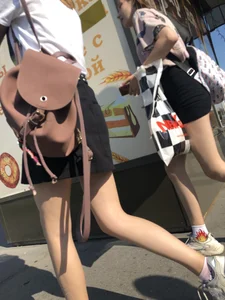 Couple of Skinny Girls in Mini-Skirts And Sneakers Street Photos