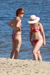 Couple of hot babes hanging out at the beach in bikinis