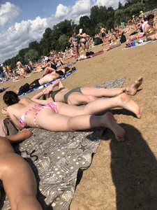 Gorgeous milf rubbing sun lotion in her skin at the beach, with a couple of her milf friends