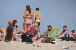 Two thick white girls in bikinis on the beach with big asses