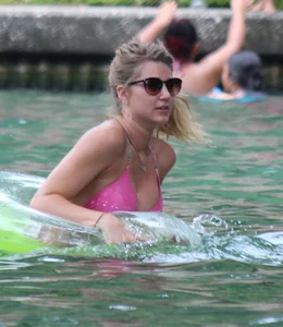 Blonde bikini girl at the pool in pink bikini top with amazing tits