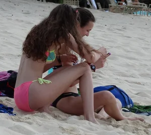 Two candid skinny teen sisters in bikinis