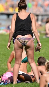 Sexy blonde girl in the park playing volleyball in her skimpy bikini