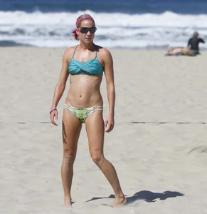 Hot girls playing beach volleyball in bikinis and shorts
