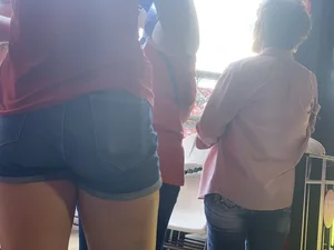 Bunch of girls in various outfits at a Cardinals baseball game