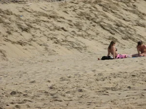 Topless beach girl with nice titties with her friend in a bikini
