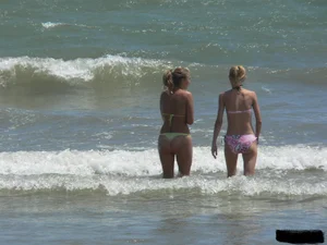 Sexy blonde on the beach in a yellow thong bikini