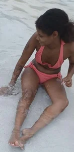 Girl in a swimsuit sitting in water