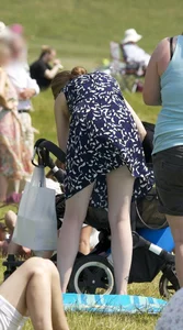 Pale milf in a skirt giving a peek at her green panties