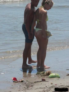 Sexy blonde on the beach in a yellow thong bikini