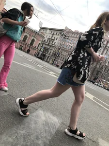 Hot pale legs of a candid girl crossing the street