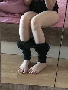 Girl Sitting in Bed with Pants Pulled Down and Bare Feet Home Mirror Selfie