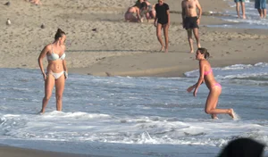 Two sexy friends out on the beach in bikinis