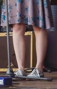 Legs Closeup of a Young Girl in a Dress Standing on Stage