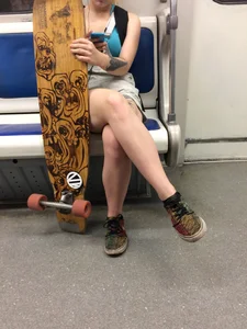 Girl with Cute Legs and a Skateboard in a Subway Train Candid Photo
