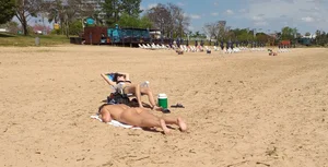 Girl laying out getting sun in a white thong bikini