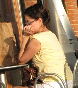 Lady in flop flops while eating showing her feet
