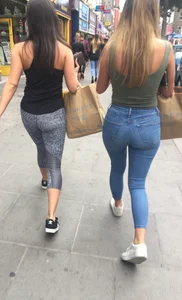Sexy girl walking in grey patterned leggings with friend in tight jeans