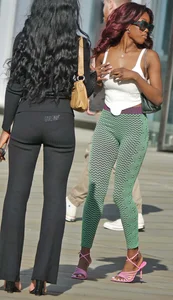 Slim ebony teens in leggings posing in the sun