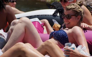 Sexy party girls in bikinis on a lake
