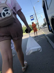Young Girl in Sandals and Shorts in a Public Bus
