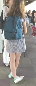Cute girl wearing a dress at the train station