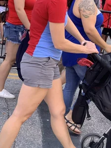 Bunch of girls in various outfits at a Cardinals baseball game