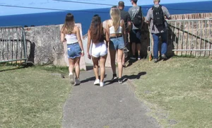 Three sexy friends in denim shorts and a skirt