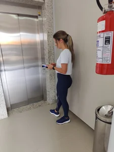 Petite girl with perfect ass waiting for the elevator