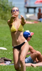 Sexy blonde girl in the park playing volleyball in her skimpy bikini