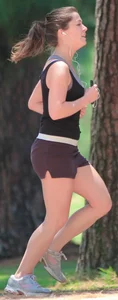 Cute girl running in short shorts