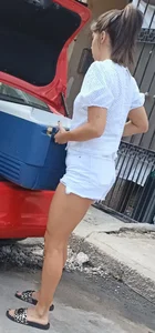Young Candid Girl in White Shorts Loading Stuff to a Car Legs Closeups