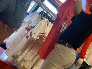 Bunch of girls in various outfits at a Cardinals baseball game