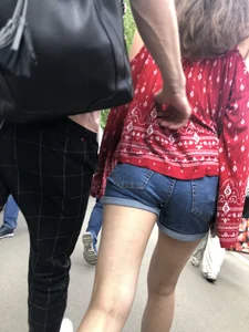 Very hot candid girl in denim shorts walking down the train platform