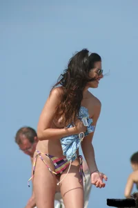 2 topless girls at the beach in thongs