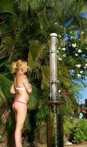 Beach shower girl with cute little ass in tiny black bikini