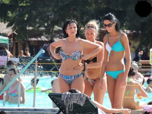 Tall and skinny brunette babe at the pool in a teal thong bikini