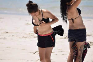 Beach girl can't keep her tits in her bikini