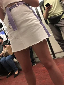 Candid Girl in a White Skirt and Sneakers With Hot Tanned Legs in Subway Train Creepshots