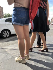 Closeup of nice legs and booty in denim shorts on a crosswalk