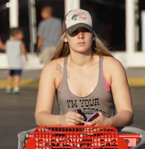 Hot blonde after shopping in short jean shorts and tank top