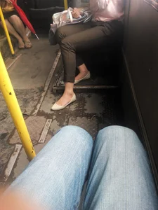 Slim Long Legs in Tight Black Jeans And Feet in Flats - Girl Sitting in a Public Bus Creepshot