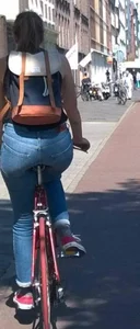 Blonde girl on a bike with a big tight ass in tight jeans